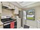 Bright kitchen featuring stainless steel appliances and ample counter space, illuminated by natural light at 4015 Mountain Springs Ln, Tampa, FL 33624