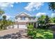 Beautiful two-story home with a well-manicured lawn, brick accents, and a three-car garage at 4117 W Platt St, Tampa, FL 33609