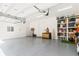 A spacious, well-lit three car garage features ample storage and pristine epoxy flooring at 4117 W Platt St, Tampa, FL 33609