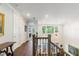 Upstairs hallway with wood floors, chandelier, and views of the living room at 4117 W Platt St, Tampa, FL 33609