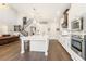 Bright and spacious kitchen with an island, stainless steel appliances, and hardwood floors at 4117 W Platt St, Tampa, FL 33609