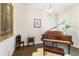 Elegant piano room with a grand piano, accent lighting, and tasteful decor at 4117 W Platt St, Tampa, FL 33609