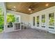 A covered outdoor living space includes a full kitchen, wood ceiling, and access to the backyard at 4117 W Platt St, Tampa, FL 33609