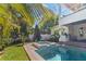An inviting backyard pool and spa feature a built-in outdoor kitchen and a meticulously landscaped yard at 4117 W Platt St, Tampa, FL 33609
