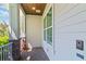 A charming front porch with brick accents and a video doorbell offers a cozy entrance to the home at 4117 W Platt St, Tampa, FL 33609