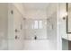 Luxury walk-in shower with dual shower heads, a built-in bench, and tiled walls at 4117 W Platt St, Tampa, FL 33609