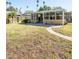 A spacious backyard featuring a sunroom area with sliding glass doors at 4126 Harrisburg Ne St, St Petersburg, FL 33703