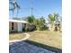 A shed with a well-kept lawn and palm trees in the background at 4126 Harrisburg Ne St, St Petersburg, FL 33703