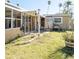 View of the backyard showing the outdoor bathroom and sunroom at 4126 Harrisburg Ne St, St Petersburg, FL 33703