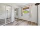 Inviting bedroom featuring mirrored closets, a bright window and wood-look flooring at 4126 Harrisburg Ne St, St Petersburg, FL 33703