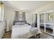 Bright bedroom featuring mirrored closets, a comfortable bed, neutral decor and wood-look flooring at 4126 Harrisburg Ne St, St Petersburg, FL 33703
