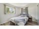 Cozy bedroom featuring a comfortable bed, neutral decor, bright window and wood-look flooring at 4126 Harrisburg Ne St, St Petersburg, FL 33703