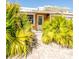 Charming front entrance adorned with lush plants and a paved walkway at 4126 Harrisburg Ne St, St Petersburg, FL 33703