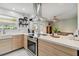 Modern kitchen featuring quartz countertops, a stainless steel range hood, and an inviting view to an outdoor patio at 4126 Harrisburg Ne St, St Petersburg, FL 33703