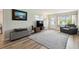 Cozy living room featuring hardwood floors, neutral tones, and a comfortable seating area at 4126 Harrisburg Ne St, St Petersburg, FL 33703