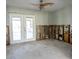 Spacious living room area with double doors leading to the outside patio and a modern ceiling fan fixture at 4126 Harrisburg Ne St, St Petersburg, FL 33703