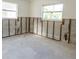 Unfinished room shows block walls, exposed studs, and two windows offering natural light at 4126 Harrisburg Ne St, St Petersburg, FL 33703