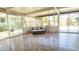 Bright and airy sunroom featuring tile floors, comfortable seating, and expansive windows at 4126 Harrisburg Ne St, St Petersburg, FL 33703