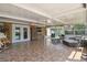 Relaxing sunroom showcases tile floors, comfortable seating, and peaceful garden views at 4126 Harrisburg Ne St, St Petersburg, FL 33703