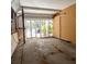 Interior of sunroom featuring bare walls and floors, and sliding glass doors at 4126 Harrisburg Ne St, St Petersburg, FL 33703