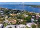 An aerial view featuring upscale homes, lush greenery, and a tranquil bay on a sunny day at 43 Aegean Ave, Tampa, FL 33606