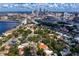 Aerial view showcases city skyline backdrop, lush foliage, and beautiful homes in a desirable location at 43 Aegean Ave, Tampa, FL 33606