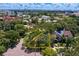 An aerial view showcases a residential neighborhood with lush trees, and a yellow outline highlights the property lines at 43 Aegean Ave, Tampa, FL 33606