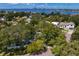 A lush neighborhood is captured from an aerial view, showcasing a tree-lined street with well-maintained houses at 43 Aegean Ave, Tampa, FL 33606
