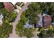 An aerial view captures a lush neighborhood street with tree-lined properties, showcasing rooftops at 43 Aegean Ave, Tampa, FL 33606