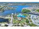 Stunning aerial view of community with large lake, clubhouse, pool, manicured lawns and a coastal neighborhood at 5128 Admiral Pointe Dr, Apollo Beach, FL 33572