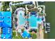 Aerial shot of the community pool, featuring a slide, a lap pool, and tropical landscaping at 5128 Admiral Pointe Dr, Apollo Beach, FL 33572