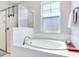 Bright bathroom features a soaking tub, glass enclosed shower, and natural light at 5128 Admiral Pointe Dr, Apollo Beach, FL 33572