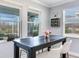 Bright dining area features pond views, gray walls, and a dark table, creating a cozy eating space at 5128 Admiral Pointe Dr, Apollo Beach, FL 33572