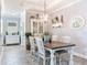 Charming dining room featuring a long wooden table and view of built in cabinets and front sitting room at 5128 Admiral Pointe Dr, Apollo Beach, FL 33572