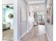 Spacious hallway with wood-look tile flooring, neutral paint, and access to multiple rooms in the house at 5128 Admiral Pointe Dr, Apollo Beach, FL 33572