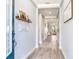 Well-lit hallway with wood-look tile flooring and neutral walls, offering a welcoming entry to the home at 5128 Admiral Pointe Dr, Apollo Beach, FL 33572