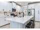 Bright, modern kitchen featuring a quartz island, stainless steel appliances, and white cabinets at 5128 Admiral Pointe Dr, Apollo Beach, FL 33572