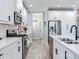 Modern kitchen with stainless appliances, white cabinets, and quartz countertops creating a bright space at 5128 Admiral Pointe Dr, Apollo Beach, FL 33572