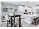 Bright kitchen with island, white cabinets, stainless steel appliances, and a dark dining table at 5128 Admiral Pointe Dr, Apollo Beach, FL 33572