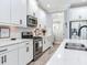 Well-lit kitchen features white cabinets, stainless steel appliances, and a seamless design at 5128 Admiral Pointe Dr, Apollo Beach, FL 33572