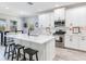 Bright kitchen features white cabinets, stainless steel appliances, a kitchen island, and barstool seating at 5128 Admiral Pointe Dr, Apollo Beach, FL 33572