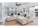 Bright living space with large sectional, open concept to kitchen with views of the lanai at 5128 Admiral Pointe Dr, Apollo Beach, FL 33572