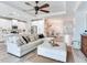 Open-concept living room features a spacious sectional sofa, ceiling fan, and kitchen view at 5128 Admiral Pointe Dr, Apollo Beach, FL 33572