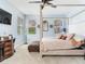 This primary bedroom boasts ample natural light and features a four-poster bed and carpet flooring at 5128 Admiral Pointe Dr, Apollo Beach, FL 33572