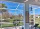 Relaxing screened-in patio offers lake views and a comfortable hammock at 5128 Admiral Pointe Dr, Apollo Beach, FL 33572
