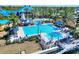 Community pool showcasing a large pool with a slide and palm trees and many chairs for relaxing at 5128 Admiral Pointe Dr, Apollo Beach, FL 33572