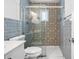 Updated bathroom featuring a glass-enclosed shower with decorative tile and sleek fixtures at 5758 20Th N Ave, St Petersburg, FL 33710