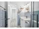 Renovated bathroom with blue tiled walls, modern vanity, and a glass-enclosed shower at 5758 20Th N Ave, St Petersburg, FL 33710