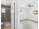 Stylishly designed bathroom featuring a tiled walk-in shower with glass door and views into the bedroom at 5758 20Th N Ave, St Petersburg, FL 33710