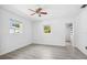 Bright bedroom with neutral walls, modern ceiling fan, and vinyl plank flooring at 5758 20Th N Ave, St Petersburg, FL 33710